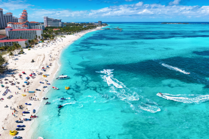 Busy summer beach with vacation homes nearby 