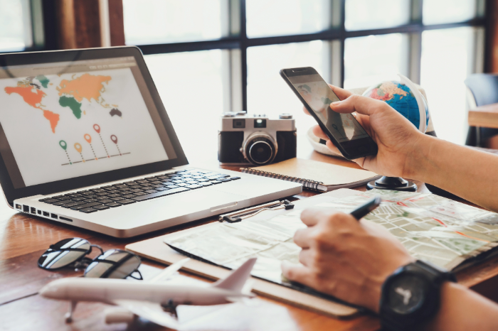 Family planning a beach vacation rental on a laptop at home