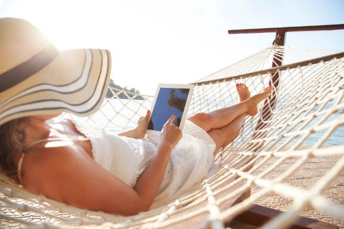 Family relaxing on a beach house deck after planning ahead