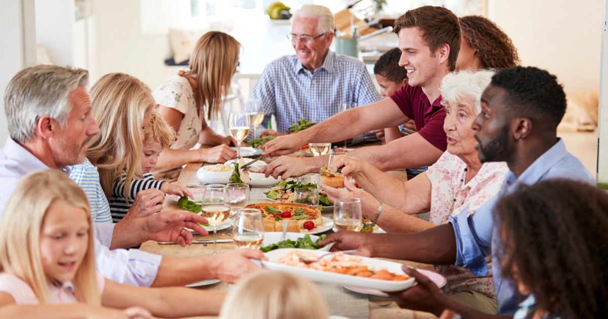 Large family cooking together in a beach vacation rental kitchen