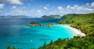 Aerial view of St. Thomas USVI with turquoise water, boats, and tropical coastline