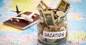 Family reviewing vacation rental costs on a laptop while planning a beach getaway