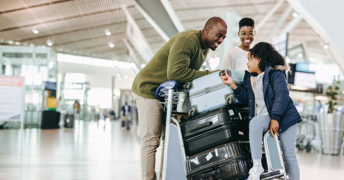 Travelers arriving at a destination airport with luggage ready for vacation