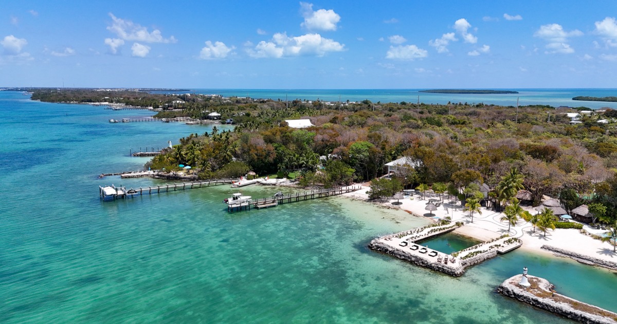 Quiet marina at sunset in Key Largo Florida with fishing boats docked in calm water