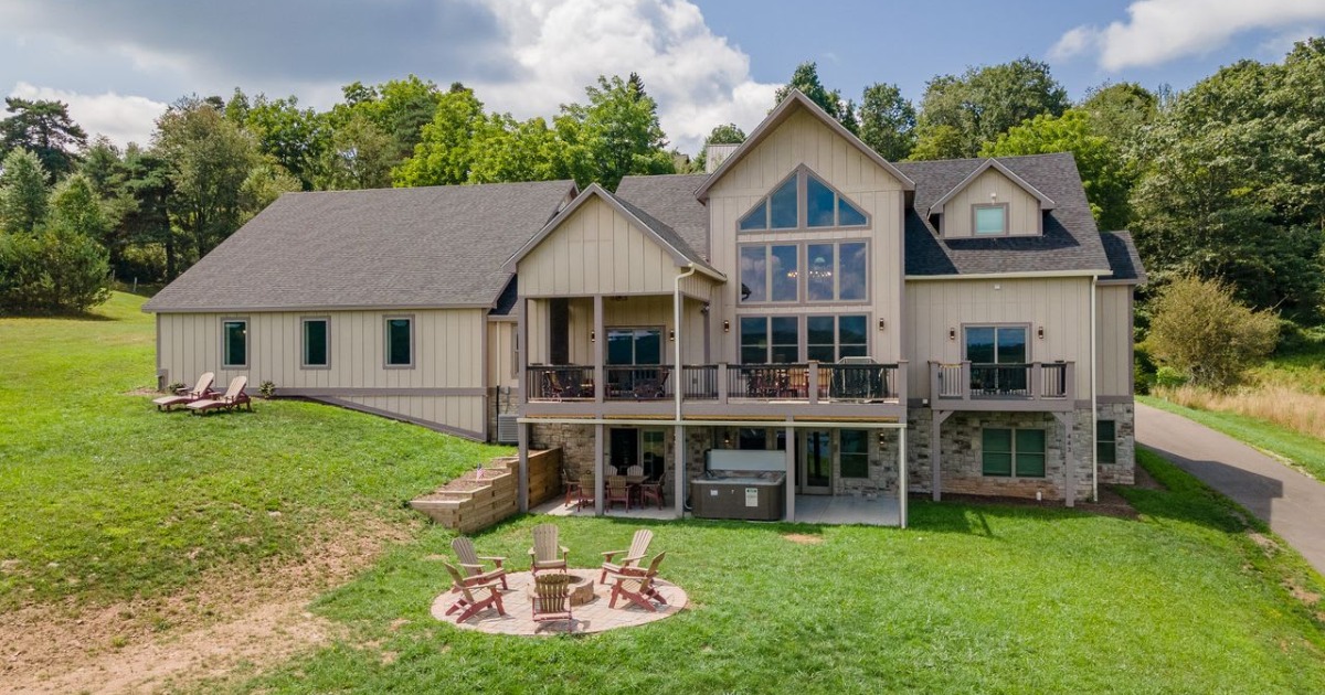 Outdoor deck of a Deep Creek Lake vacation home with Adirondack chairs and mountain views at sunset