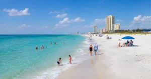 panama-city-travel-guide | Swack Vacations Wide view of Panama City Beach shoreline with families enjoying the Gulf
