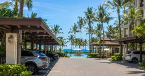 Resort parking deck with covered spaces and pool area visible in the background