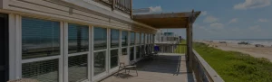 Jamaican Me Crazy beachfront vacation home on stilts with Gulf-facing balcony in Jamaica Beach, Galveston Island, Texas