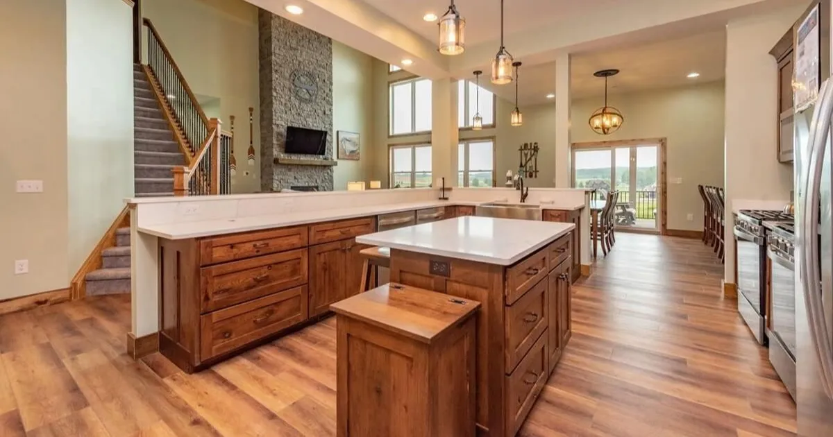 Large open kitchen with granite countertops and a long dining table set for a group