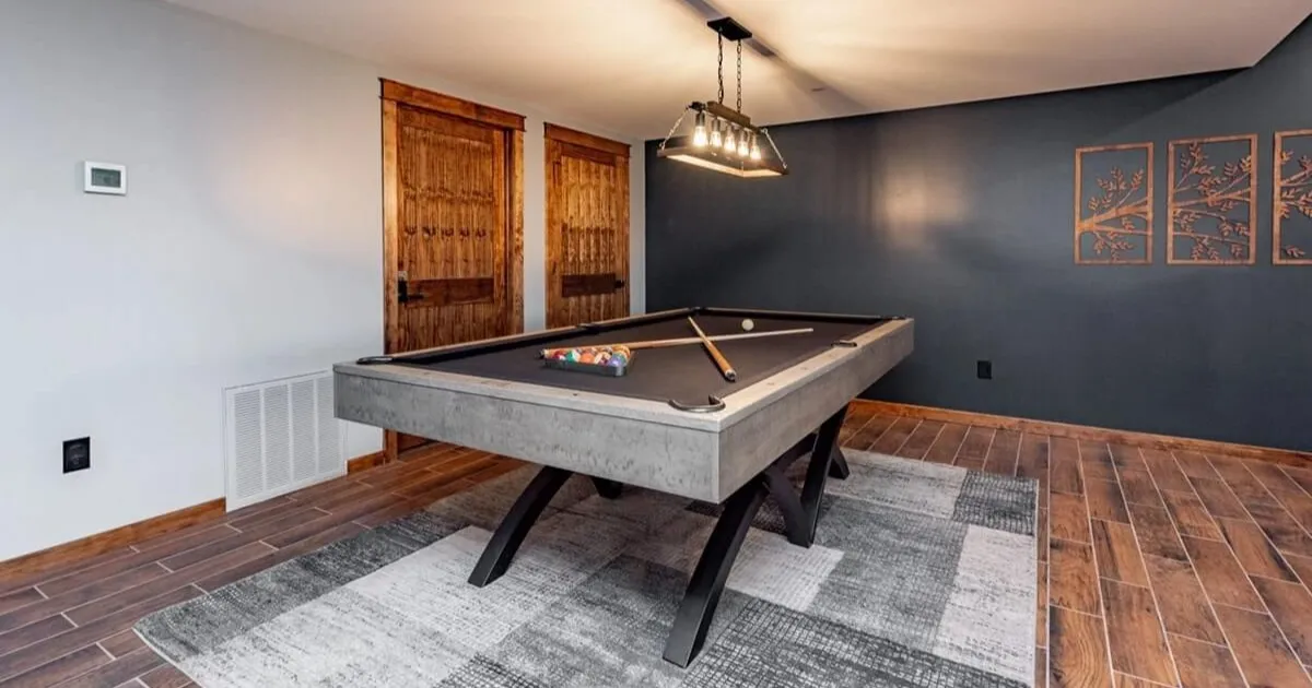 Family game room with pool table inside a large vacation rental home
