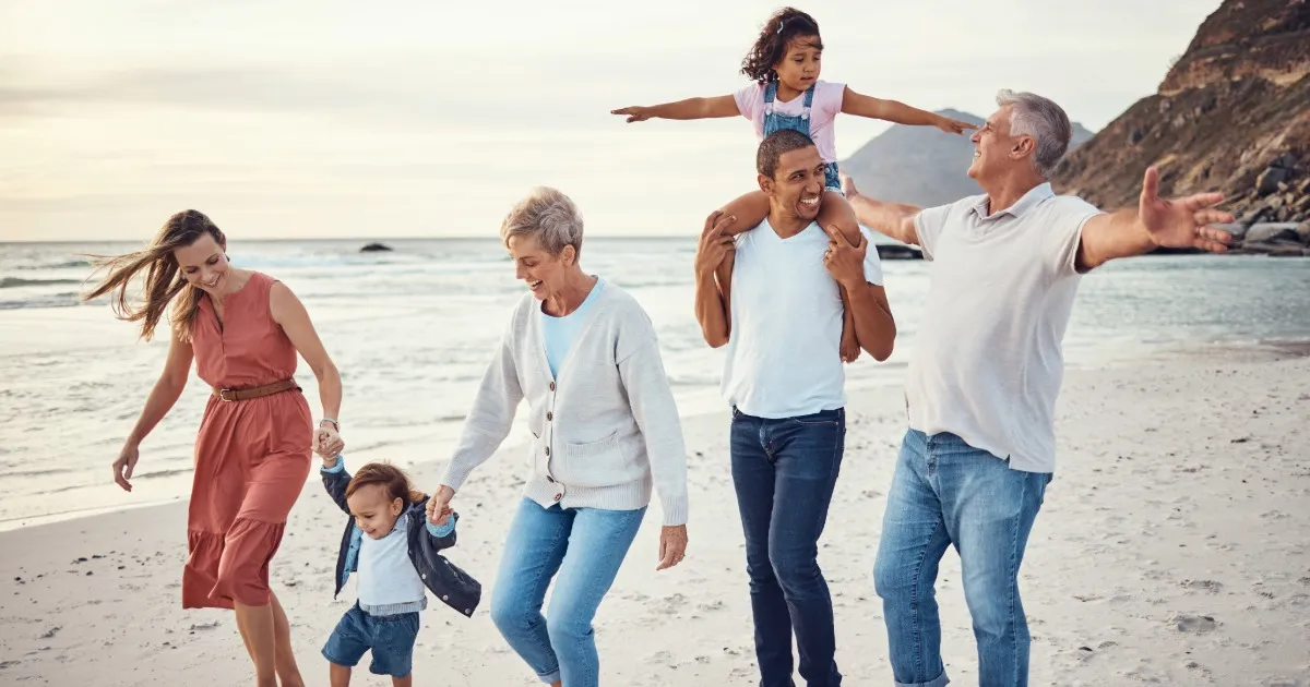 Family with young children walking toward the beach from a Swack Vacations rental home