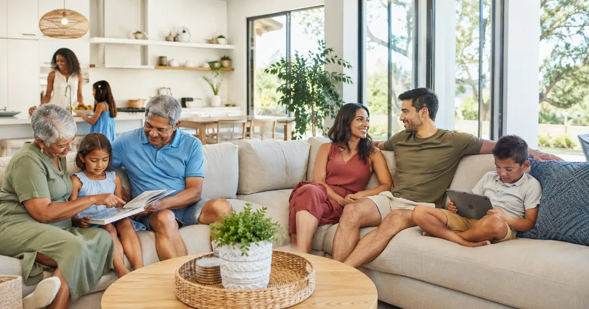 Multi-generational family relaxing together in a bright, roomy vacation home