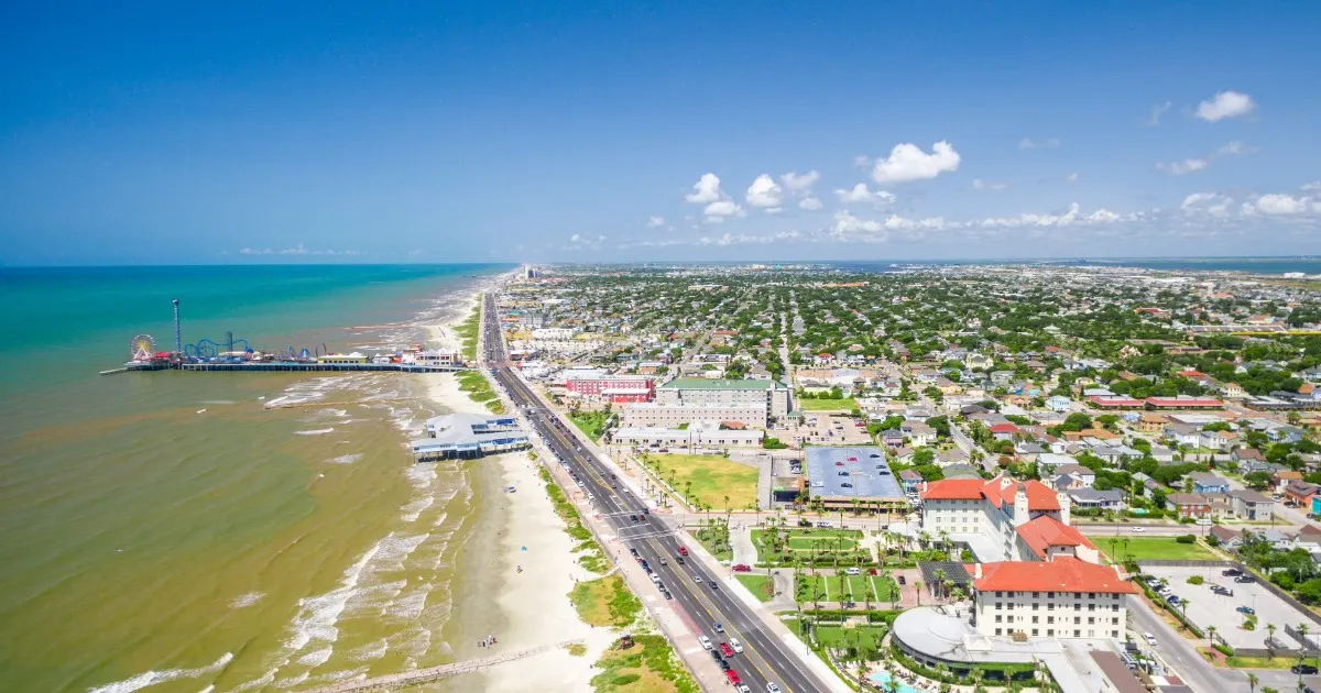 Elevated stilt beach homes lining a quiet street in Jamaica Beach, TX on Galveston Island