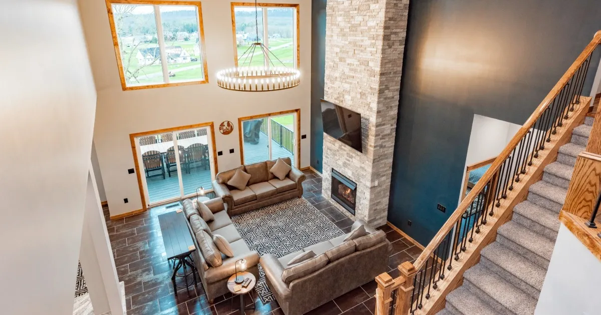 Cozy vacation home great room with a stone fireplace and comfortable seating