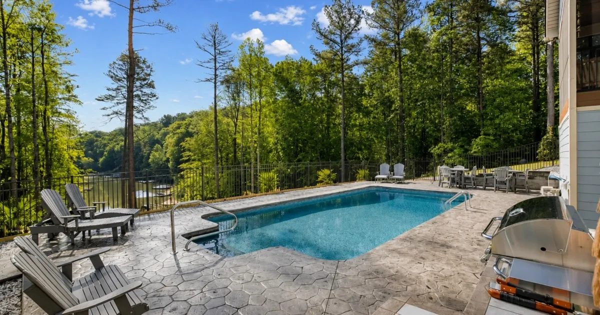 Backyard pool and patio area at a lakefront vacation home
